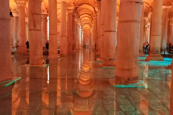 Orange-lit Basilica Cistern columns and mirrored water, highlight stop on a private Istanbul tour