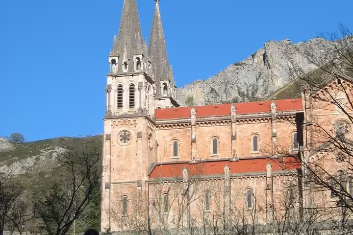 Discover the stunning Basilica of Covadonga nestled in the scenic Asturian mountains, part of the 14-day tour.