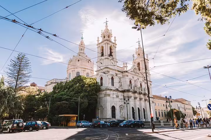 Explore the majestic Basilica da Estrela with its stunning Baroque architecture on a Tuk Tuk tour in Lisbon.