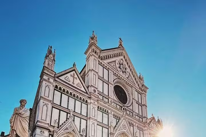 Sunlit facade of Basilica di Santa Croce in Florence, showcasing Gothic architecture on a four-hour historical tour.