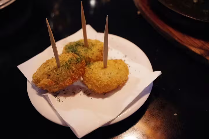Basque pintxos croquettes on a plate, a tasty stop on the Bilbao e-scavenger hunt self-guided tour