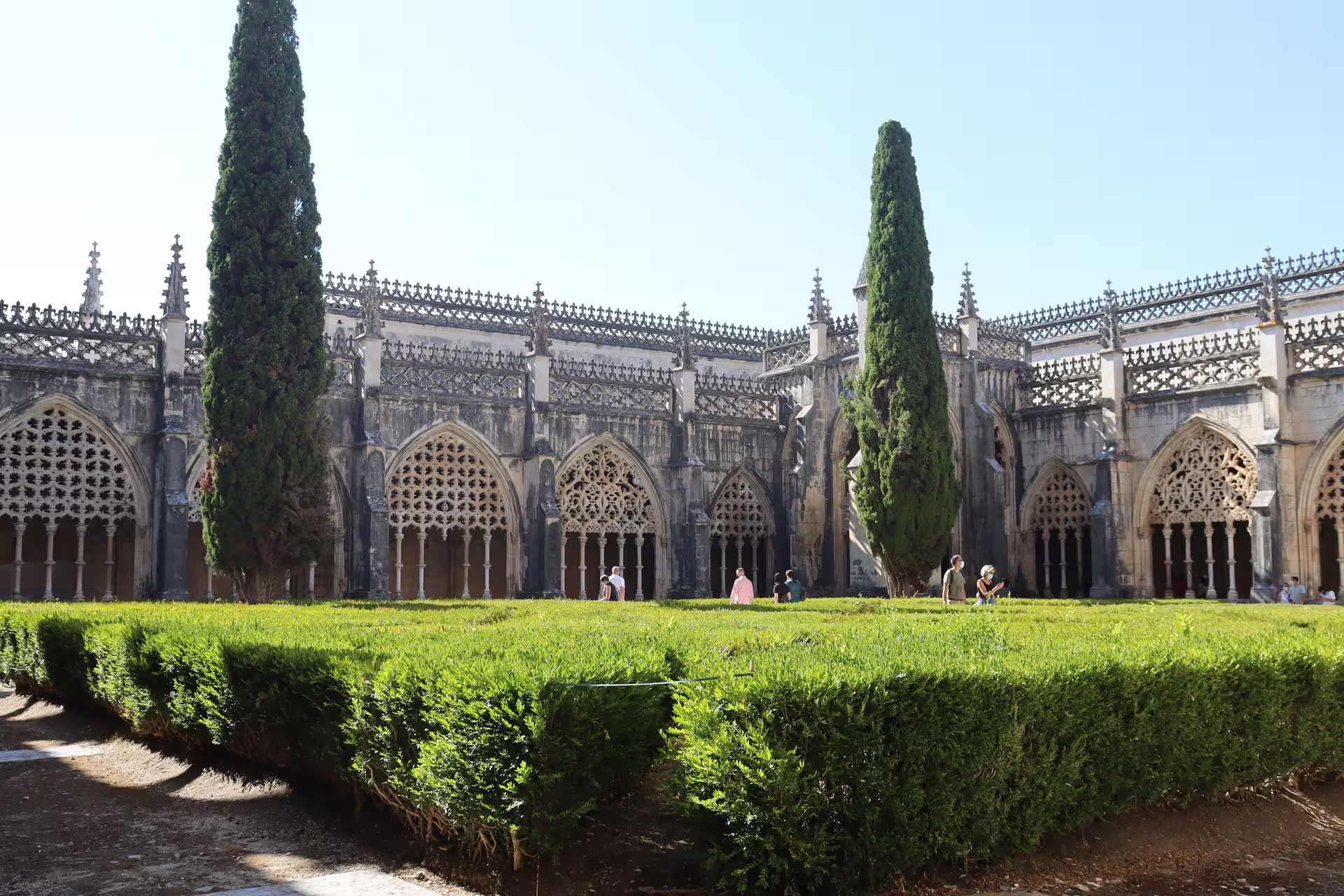 Gothic architecture of Batalha Monastery with lush gardens, featured in a private tour through Tomar, Fátima, and Batalha sites.