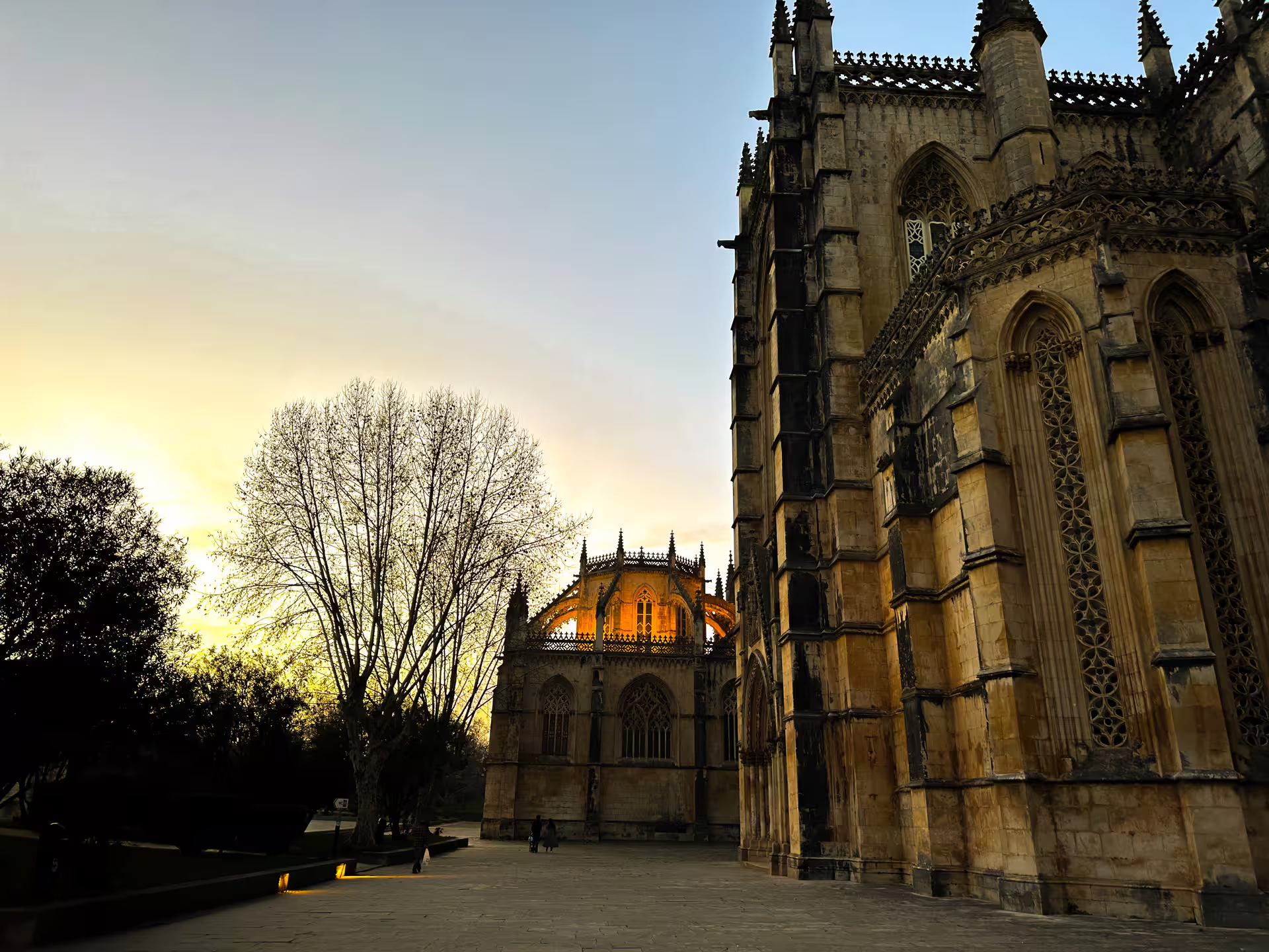 Sunset view of Batalha Monastery's intricate Gothic architecture, a key stop on the Lisbon to Porto day trip.