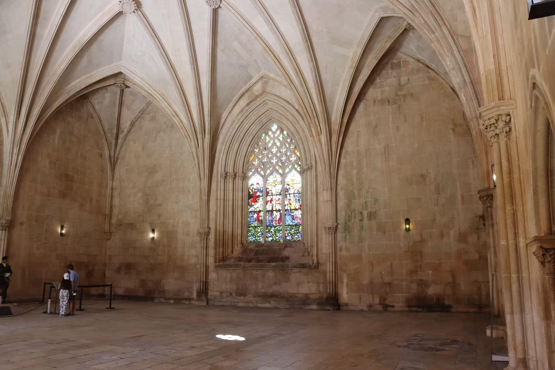 Interior view of Batalha Monastery with stunning stained glass and vaulted ceilings, featured in Tomar, Fátima, and Batalha tour.
