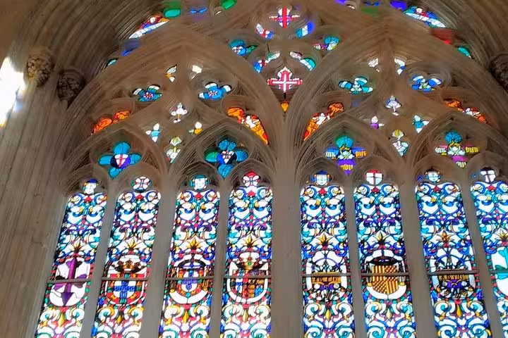 Vibrant stained glass windows at Batalha Monastery, highlighting the intricate Gothic architecture on a private tour.