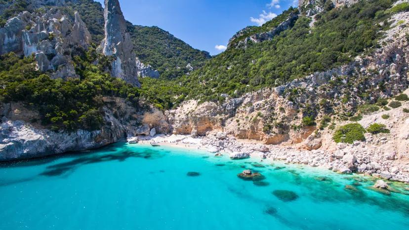 Stunning view of Cala Goloritzè's turquoise waters and rugged cliffs, ideal for Baunei trekking adventures.