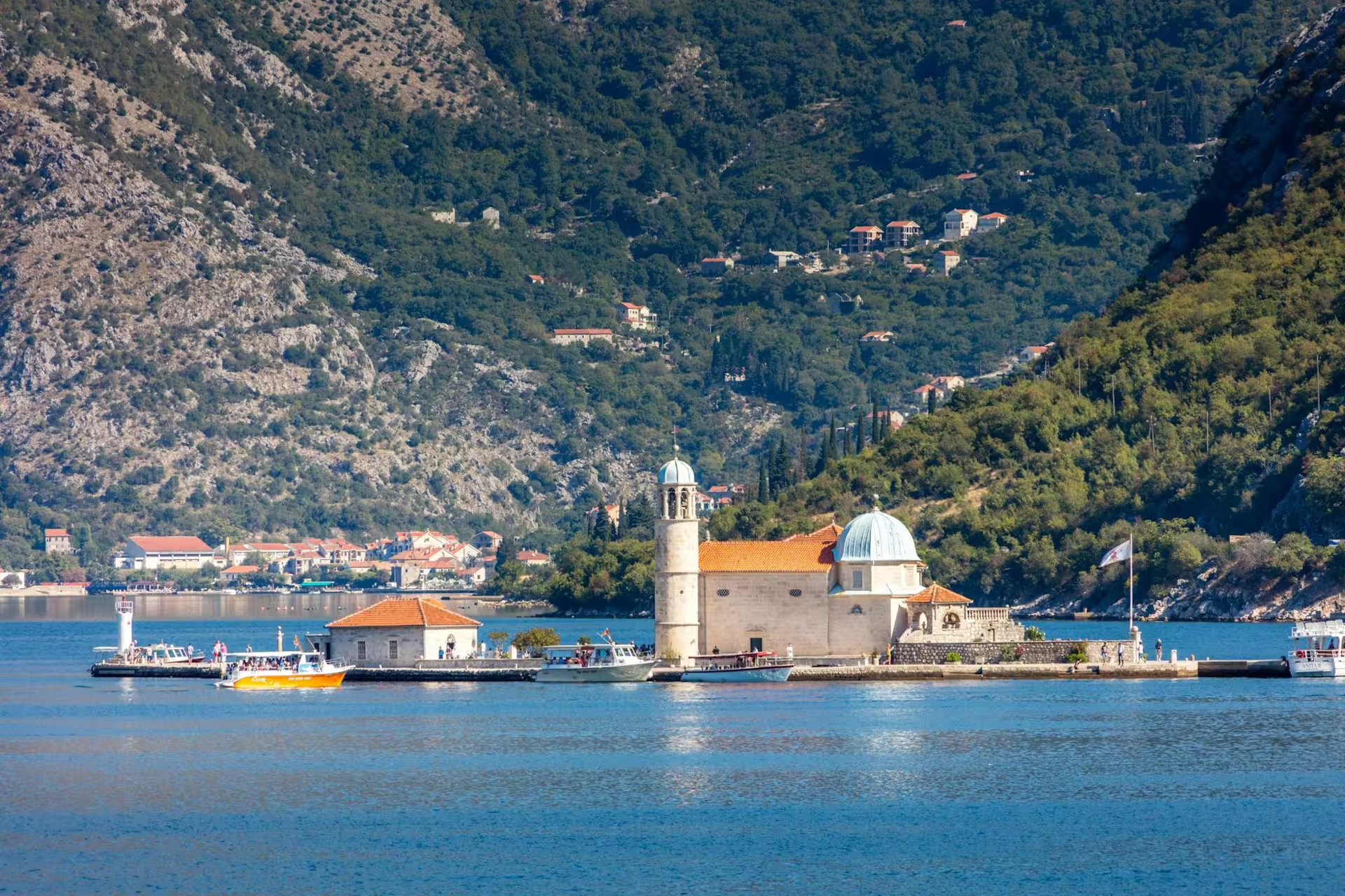 Boats dock at Our Lady of the Rocks in the Bay of Kotor, Montenegro, on a Dubrovnik cruise excursion