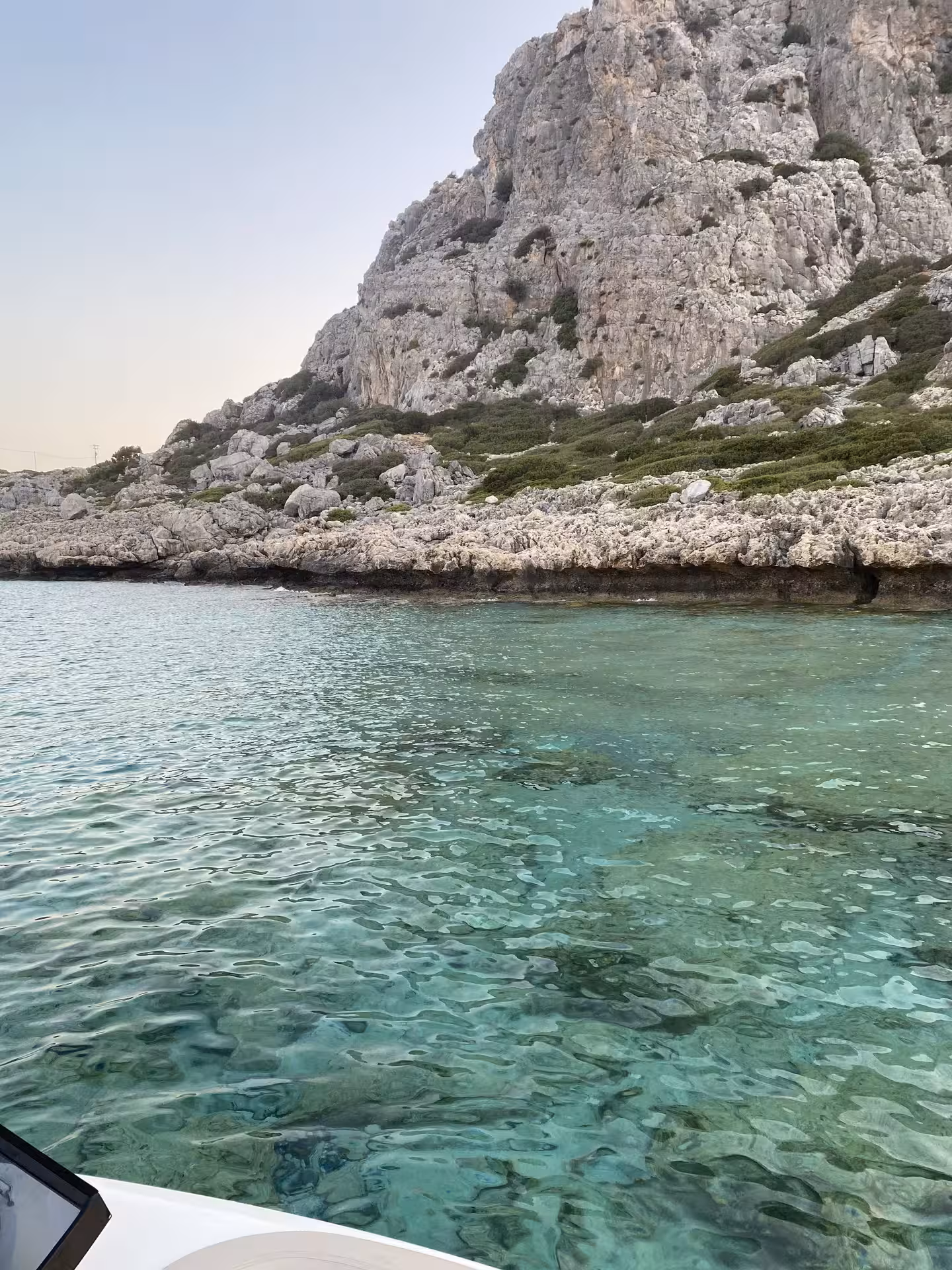 Crystal-clear turquoise cove by limestone cliffs, stop on Bayliner M17 cave and snorkelling tour