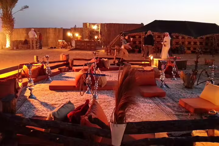 Bedouin desert camp dinner setup in Sharm El Sheikh with cushions, lanterns and shisha after ATV ride
