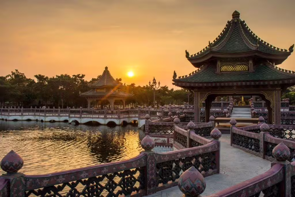 Traditional Chinese pavilion overlooking a serene lake at sunset, capturing Beijing's cultural and scenic beauty.