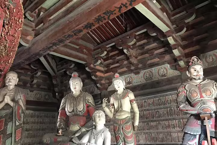 Detailed temple interior with statues on a Beijing to Pingyao and Xian bullet train private tour.