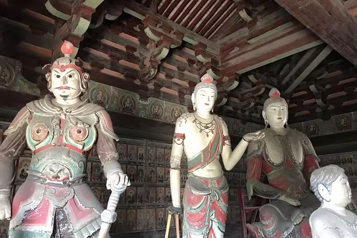 Intricate statues in a historic temple on a private tour from Beijing to Pingyao and Xian by bullet train.