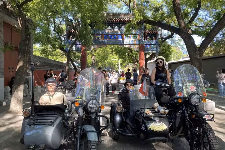 Visitors on vintage sidecars explore Beijing, capturing the charm of traditional architecture and vibrant street life.