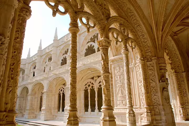 Explore the intricate Gothic architecture of Jerónimos Monastery on a Belem private day trip with history and local tasting.