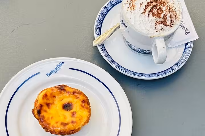 Delicious pastel de nata and a cappuccino at Pastéis de Belém, perfect treat on your Belem private tour.