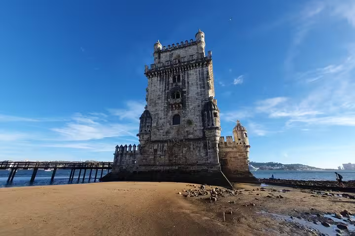 Belem Tower under a clear blue sky, a highlight of the Lisboa Old Town, New Town & Belem Private Half-Day Tour.
