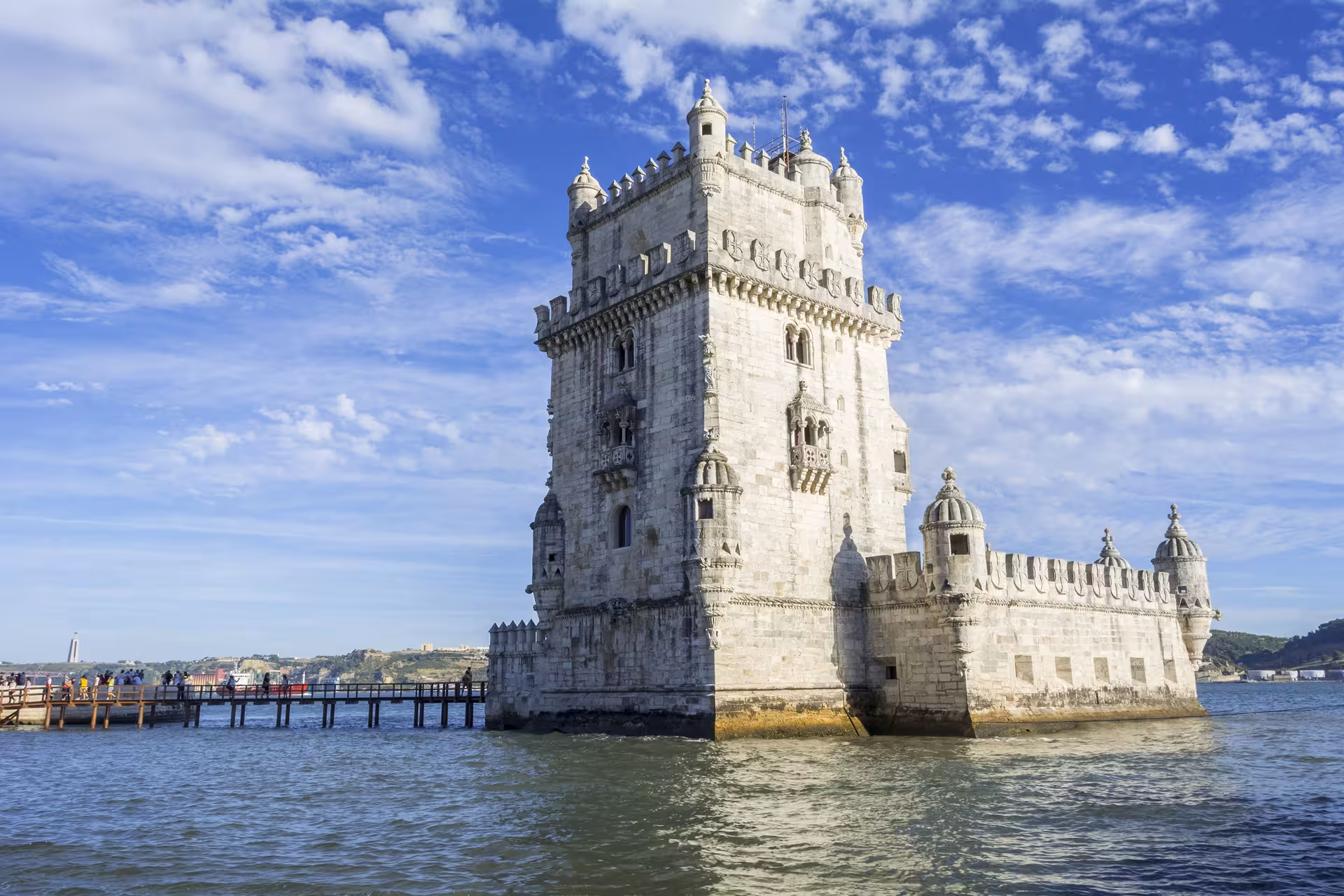 Capture of the iconic Belém Tower under a vibrant blue sky on a sunny day in Lisbon, perfect for a private city tour.