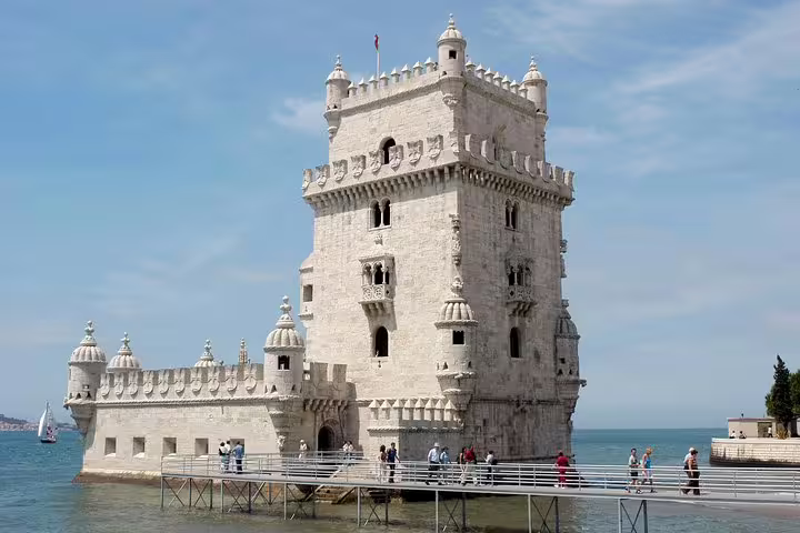 Explore the iconic Belém Tower on a Full Day Small Group Tour in Lisbon, showcasing its stunning architecture by the Tagus River.