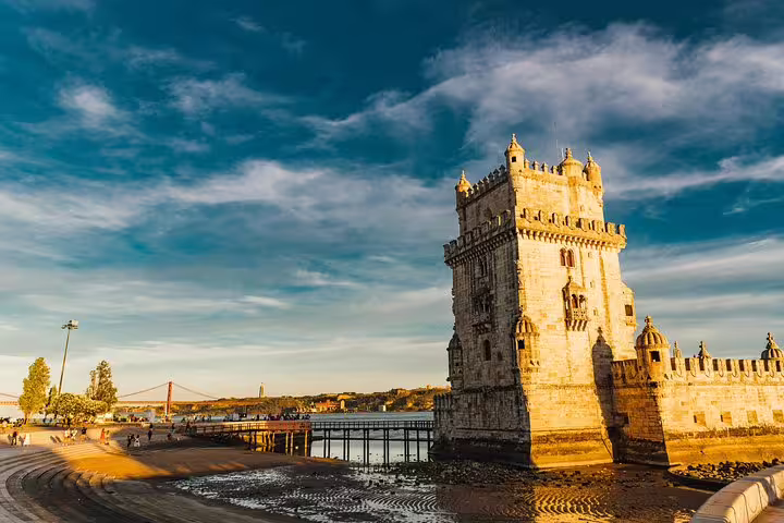 Historic Belém Tower lit by golden sunlight against a vibrant sky, a must-see in Lisbon's Belém District.