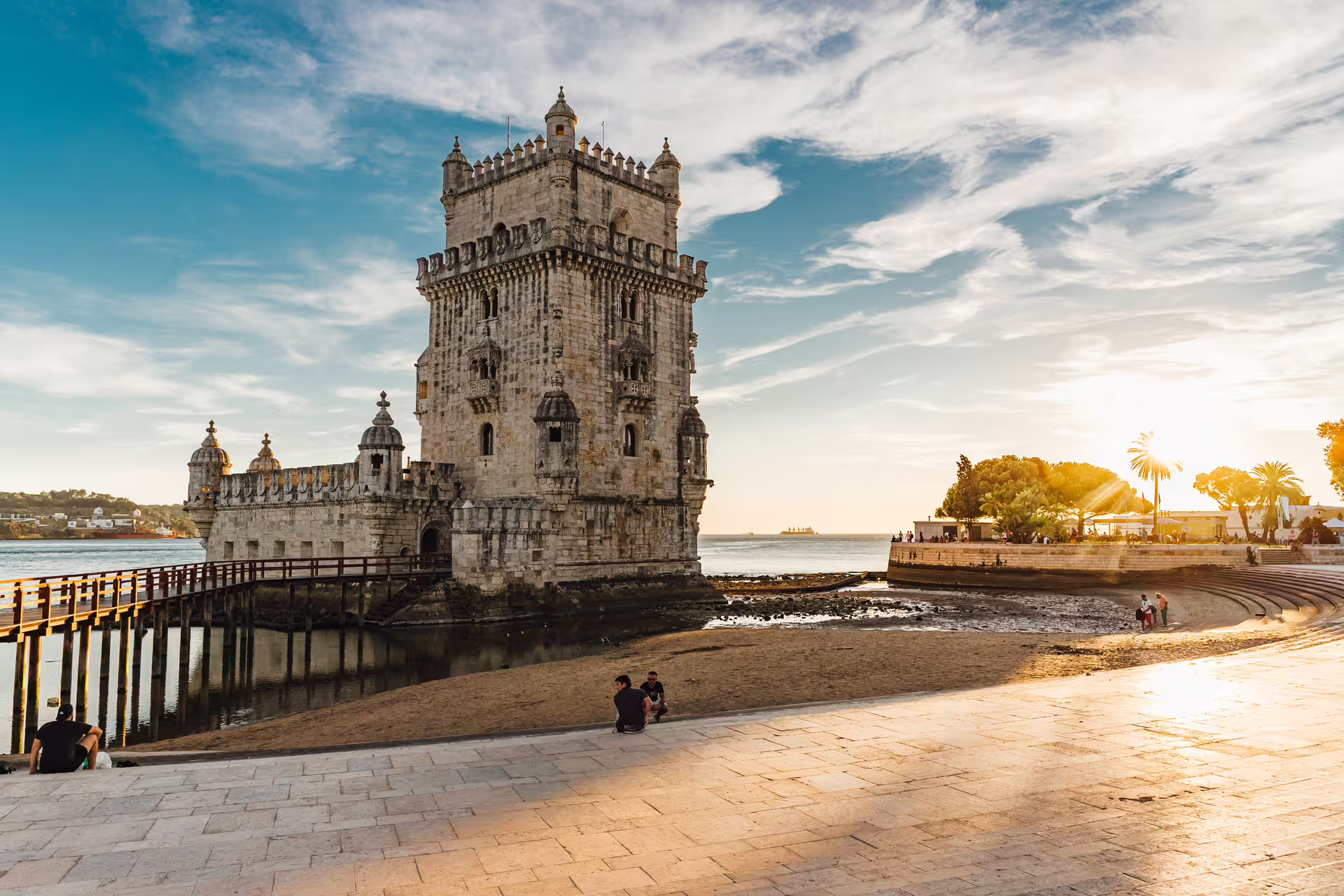Sunset view of the iconic Belém Tower by the Tagus River, a highlight of Lisbon's historical sightseeing tours.