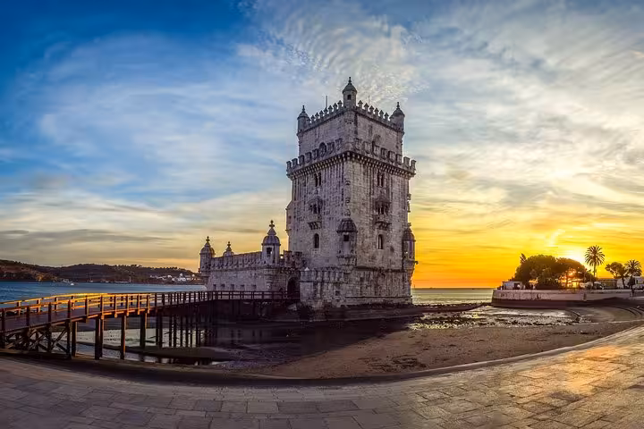 Sunset view of Belém Tower by the Tagus River in Lisbon, a highlight of the 6-day tour from Porto.