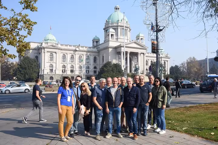 Visitors posing in front of the grand National Assembly building in Belgrade, Serbia.