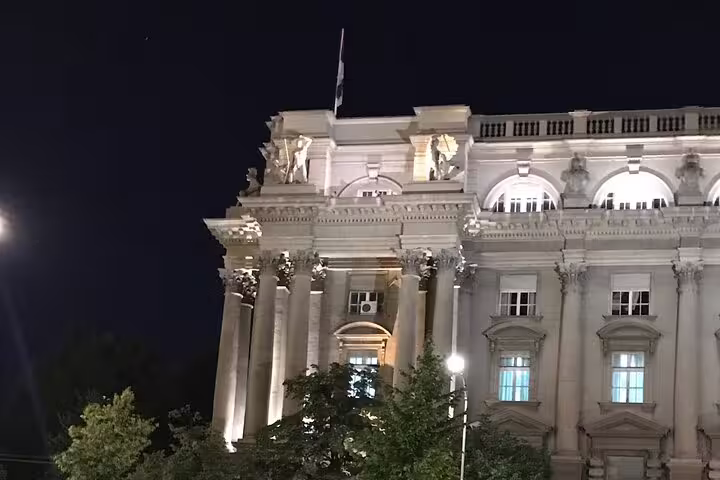 Illuminated neoclassical government building in Belgrade, key stop on Russian White Emigration history tour