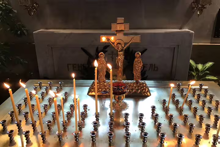 Lit candles before an Orthodox crucifix in Belgrade, a stop on the White Emigration Russian Revolution tour