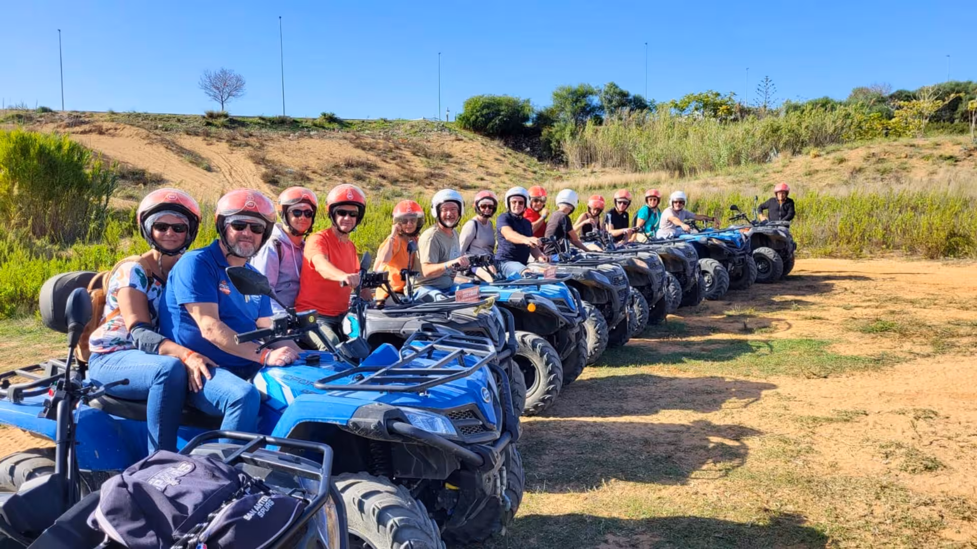 Happy group on ATVs ready for a thrilling 3-hour tour through the breathtaking landscapes of Belice Valley.