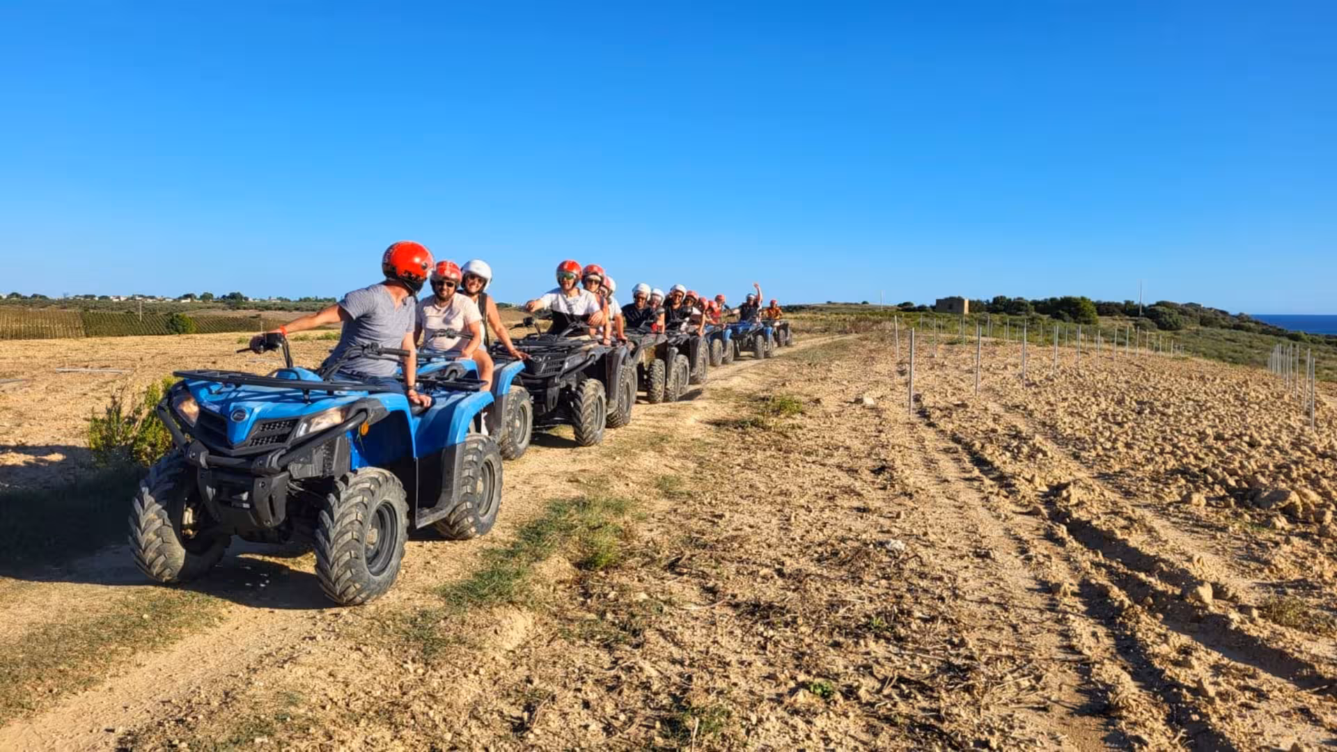 Group enjoying a scenic adventure on the Belice Valley 3-hour ATV tour under a clear blue sky.