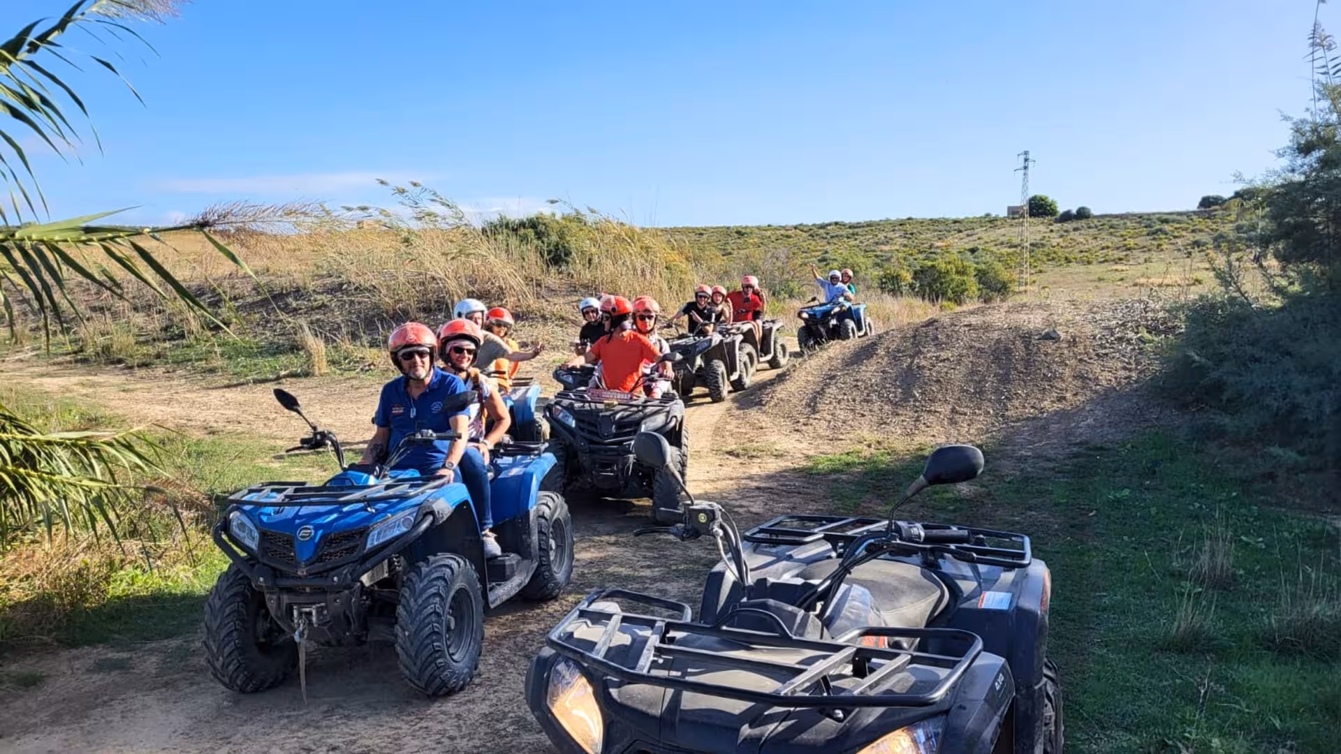 Excited participants line up for the Belice Valley ATV tour, ready to explore rugged terrains.