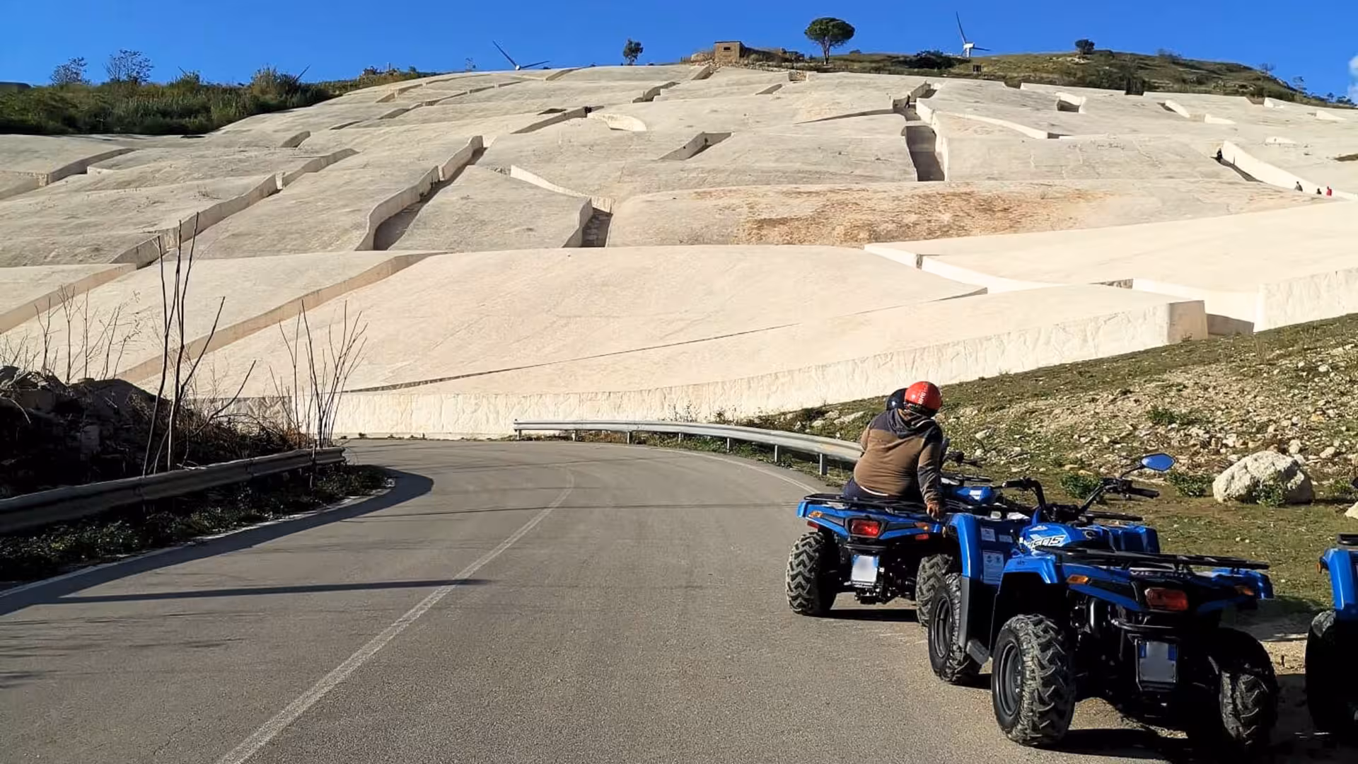 ATV rider exploring scenic Belice Valley on a 3-hour tour with stunning rock formations and clear blue skies.