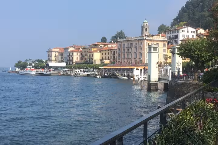 Bellagio waterfront on Lake Como with ferry docks, pastel buildings and cruise views on Milan day trip