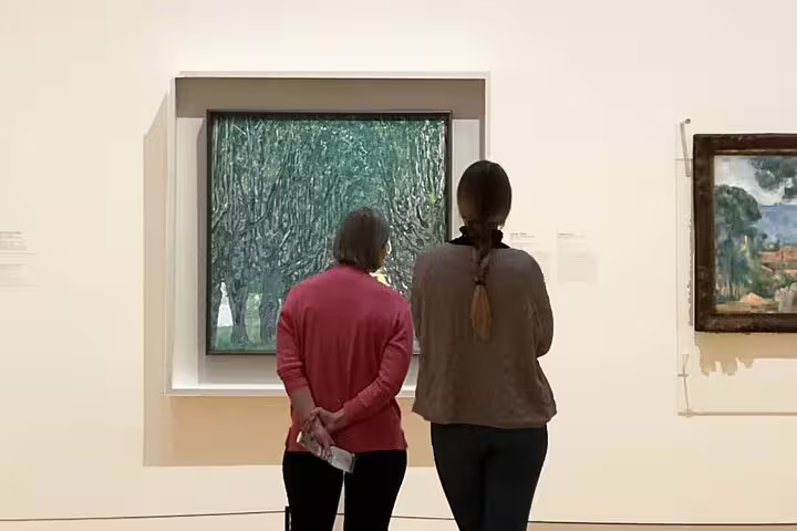 Two visitors admire a painting in the Belvedere, part of the private themed tour exploring Viennese art with an expert.