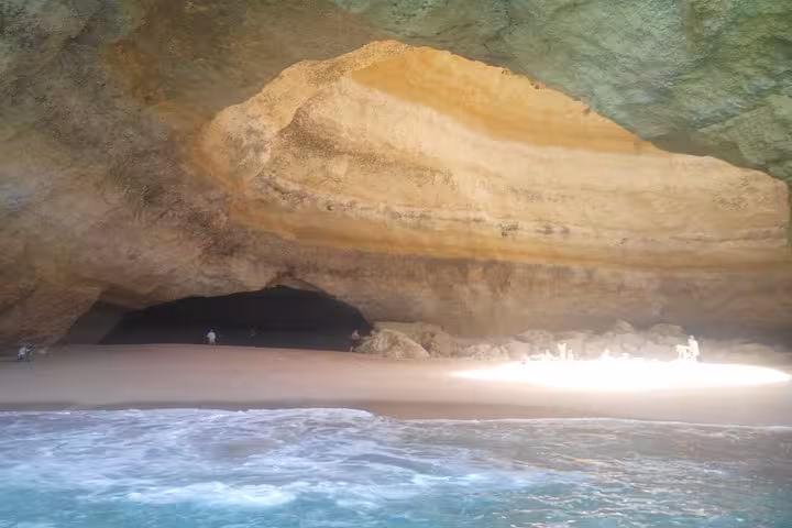 Stunning Benagil Cave with sunlit sandy beach and turquoise waters, a highlight of Algarve's private coastal tour.