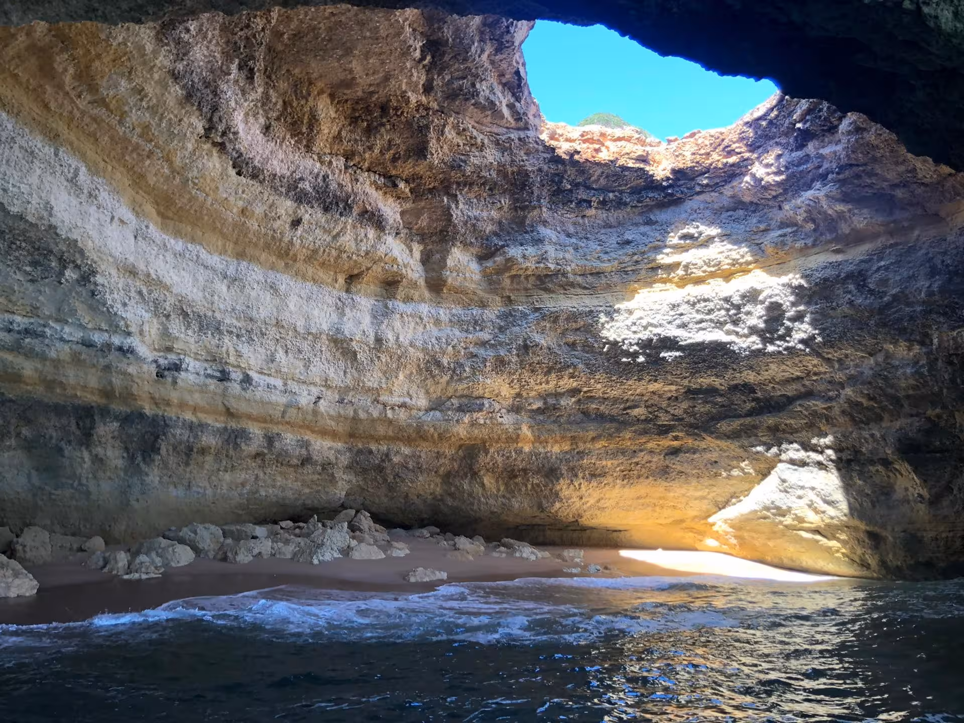 Private Algarve Benagil Cave boat tour view of skylight dome, golden cliffs and hidden beach by the sea