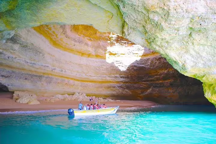 Tourists explore the stunning Benagil Cave by boat during the 3-Day Private Algarve Tour from Lisbon.