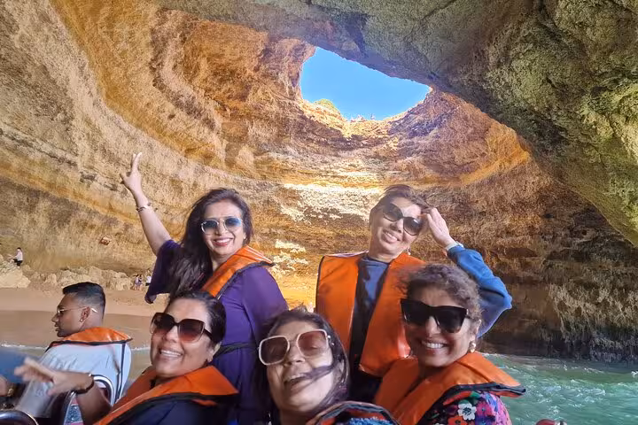 Happy group on Benagil Cave boat trip, Algarve day tour from Lisbon with all-inclusive private transfer