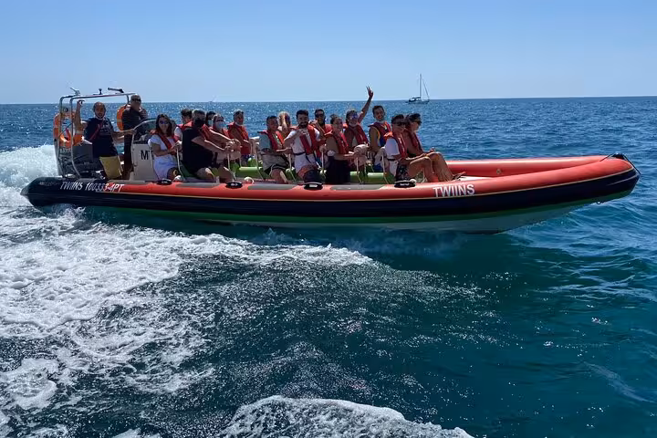 Tourists enjoying the view inside the Benagil Cave on a boat tour