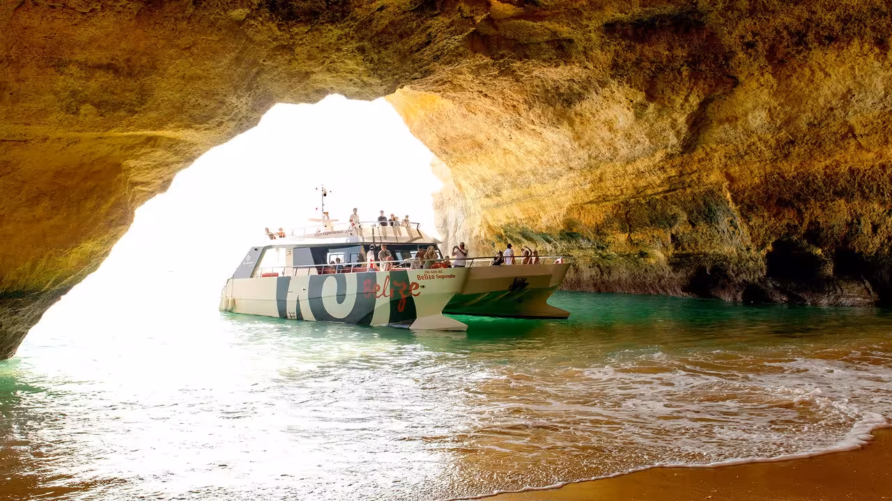 Belize catamaran sailing inside the iconic Benagil Sea Cave on a Portimao dolphins and caves boat tour Algarve