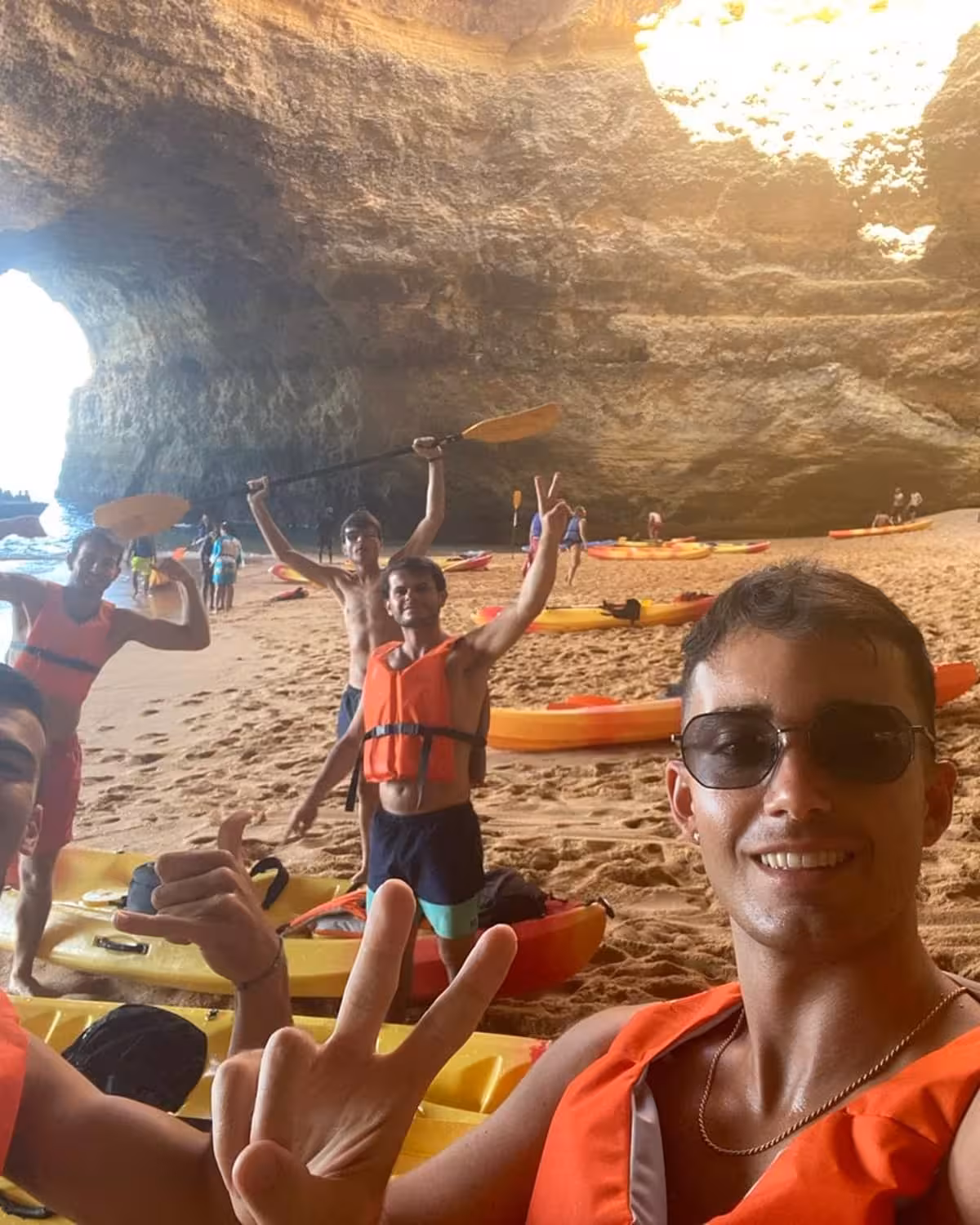 Friends in life jackets with kayaks inside Benagil Cave, Algarve sea cave adventure kayak rental