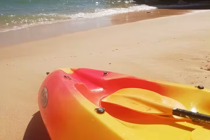 Red and yellow kayak on Algarve beach before Benagil cave guided kayak tour along the sea caves