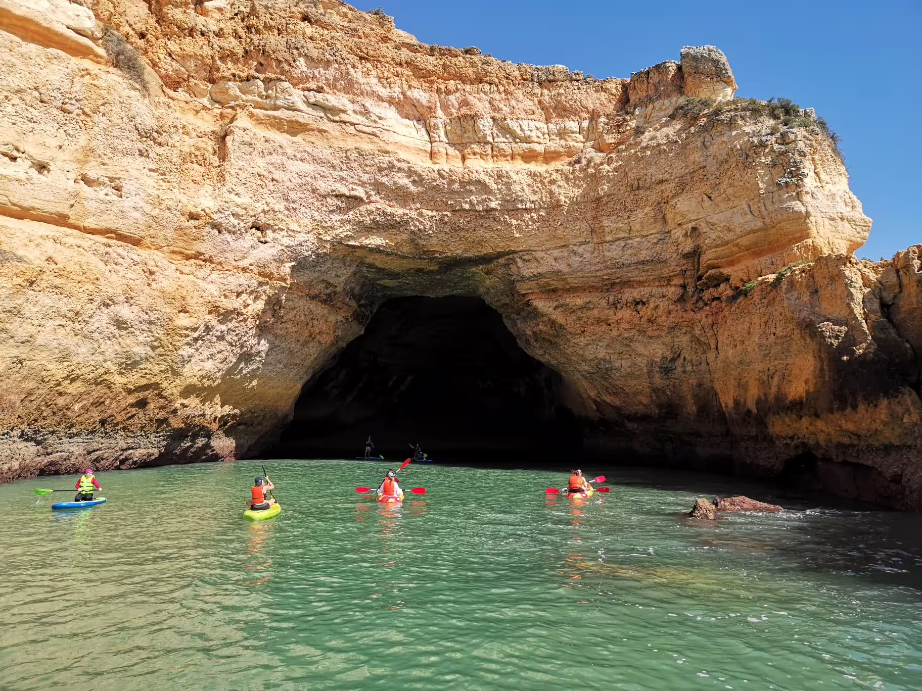 Paddle into the famous Benagil Cave with a guided kayak tour, enjoying the Algarve's breathtaking cliffs and clear waters.