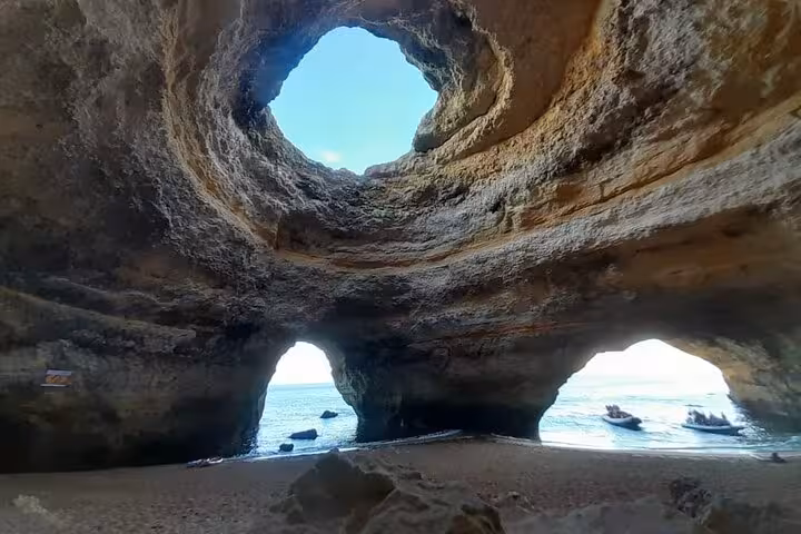 Inside Benagil Cave Algarve, skylight dome and twin arches opening to the sea on a guided kayak tour