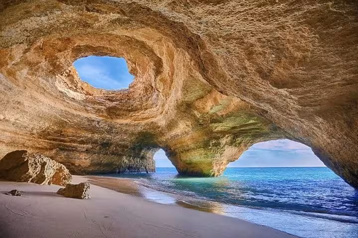 Inside Benagil Cave Algarve with skylight dome and turquoise water, highlight of guided kayak sea caves tour