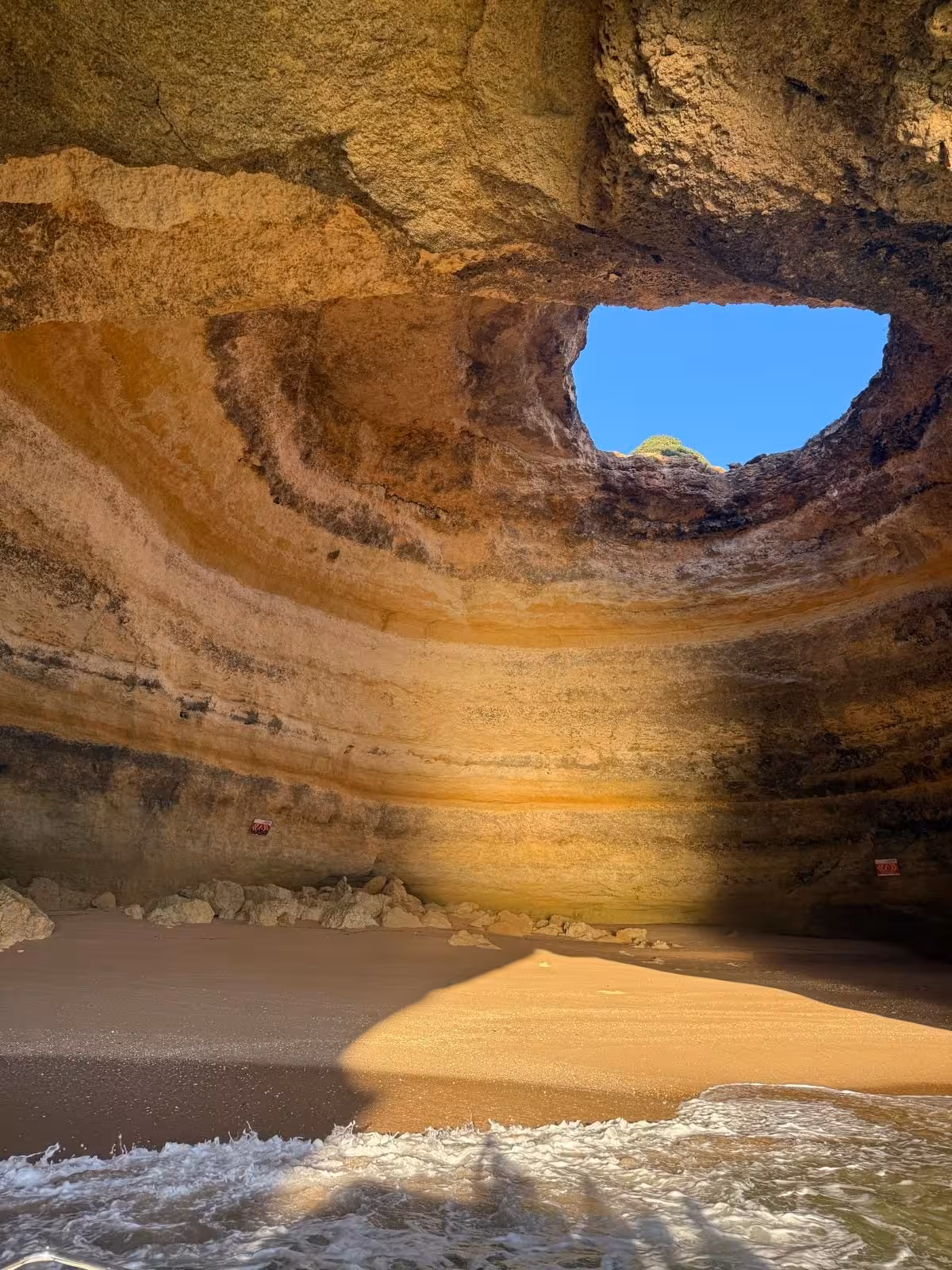 Stunning interior of Benagil Cave with natural skylight and sandy beach on the Seven Hanging Valleys guided tour Algarve