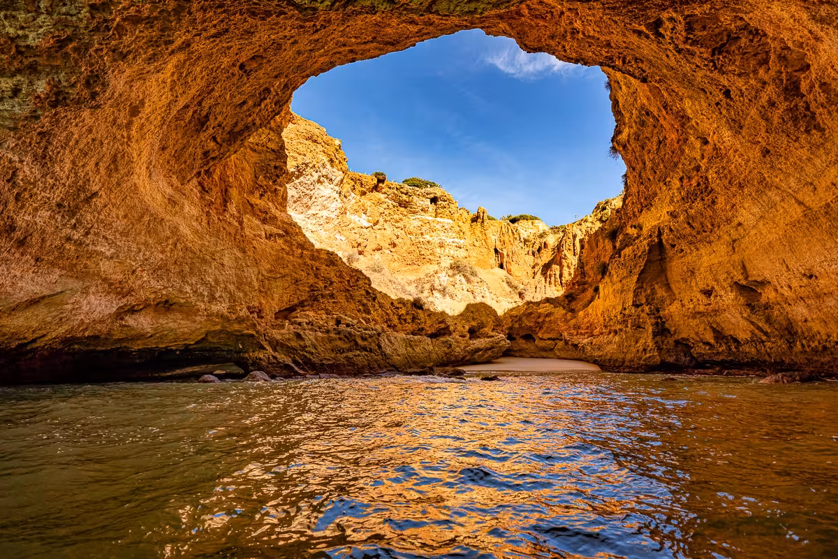 Stunning view of Benagil Cave with sunlight pouring through the natural rock arch, Algarve coastal tour highlight.