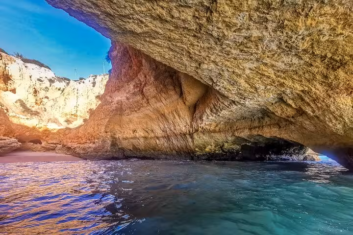 Boat-level view inside Benagil Caves, Algarve sea grotto on private tour from Lisbon with ocean waters