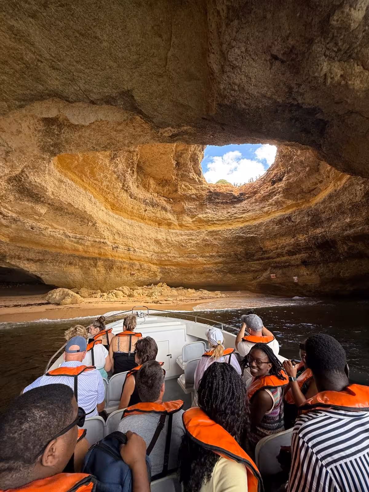 Visitors in life jackets on a Benagil Caves boat tour admire the iconic skylight and secluded beach inside the Algarve sea cave