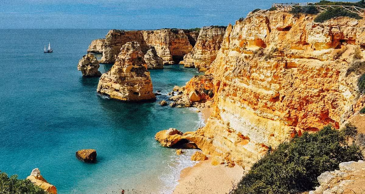 Golden Algarve cliffs and sea stacks at Marinha Beach with turquoise Atlantic water on scenic Portugal coastal boat tour route